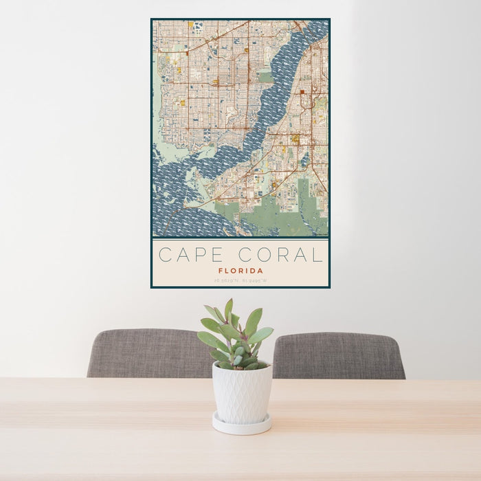 24x36 Cape Coral Florida Map Print Portrait Orientation in Woodblock Style Behind 2 Chairs Table and Potted Plant