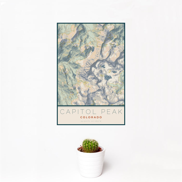 12x18 Capitol Peak Colorado Map Print Portrait Orientation in Woodblock Style With Small Cactus Plant in White Planter