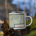 Right View Custom Carson City Nevada Map Enamel Mug in Woodblock on Grass With Trees in Background