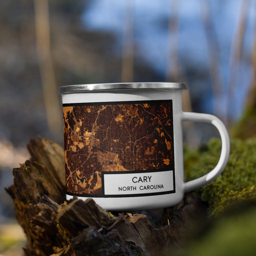 Right View Custom Cary North Carolina Map Enamel Mug in Ember on Grass With Trees in Background