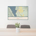 24x36 Cascade Idaho Map Print Lanscape Orientation in Woodblock Style Behind 2 Chairs Table and Potted Plant