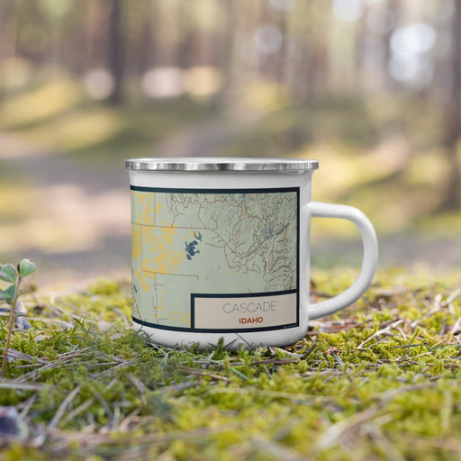 Right View Custom Cascade Idaho Map Enamel Mug in Woodblock on Grass With Trees in Background