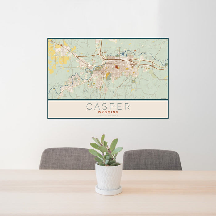 24x36 Casper Wyoming Map Print Landscape Orientation in Woodblock Style Behind 2 Chairs Table and Potted Plant