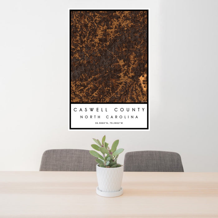 24x36 Caswell County North Carolina Map Print Portrait Orientation in Ember Style Behind 2 Chairs Table and Potted Plant