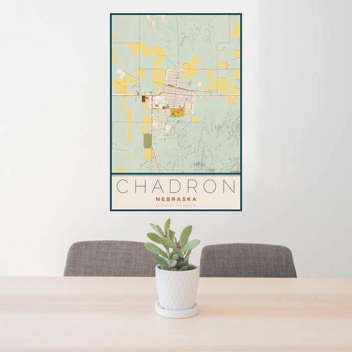 24x36 Chadron Nebraska Map Print Portrait Orientation in Woodblock Style Behind 2 Chairs Table and Potted Plant