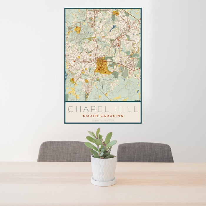 24x36 Chapel Hill North Carolina Map Print Portrait Orientation in Woodblock Style Behind 2 Chairs Table and Potted Plant