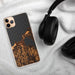 Custom Charlevoix Michigan Map Phone Case in Ember on Table with Black Headphones