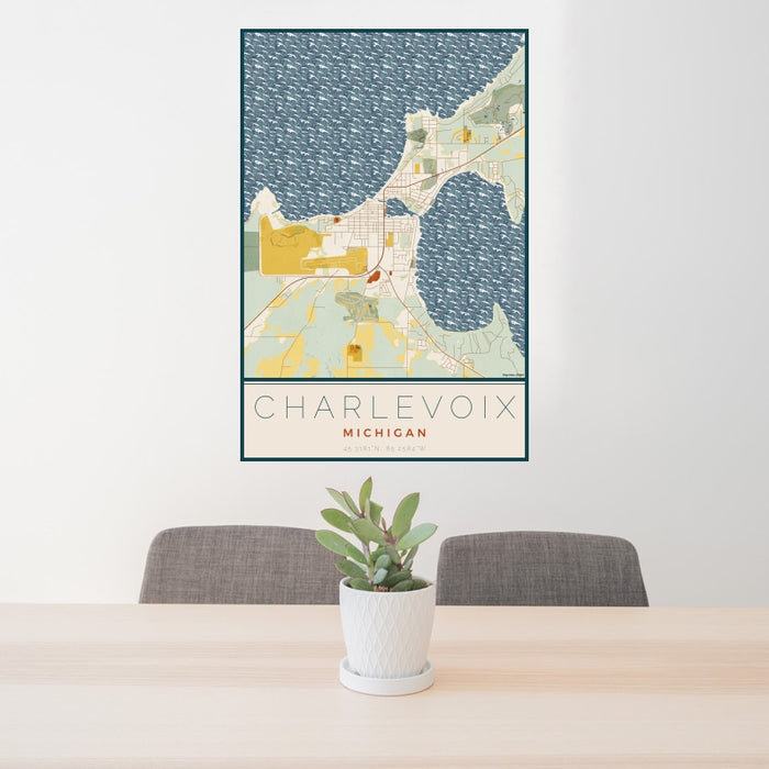 24x36 Charlevoix Michigan Map Print Portrait Orientation in Woodblock Style Behind 2 Chairs Table and Potted Plant