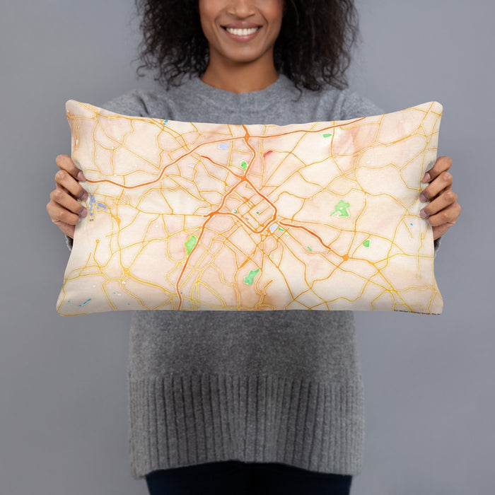 Person holding 20x12 Custom Charlotte North Carolina Map Throw Pillow in Watercolor