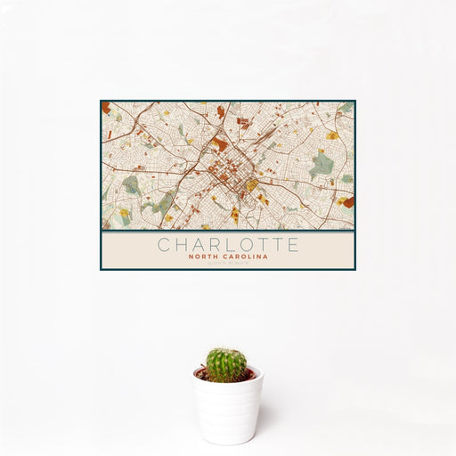 12x18 Charlotte North Carolina Map Print Landscape Orientation in Woodblock Style With Small Cactus Plant in White Planter