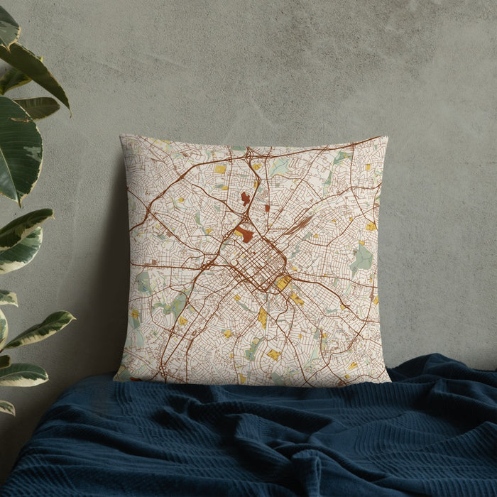 Custom Charlotte North Carolina Map Throw Pillow in Woodblock on Bedding Against Wall