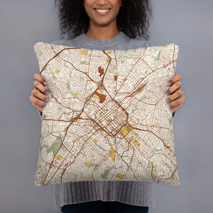 Person holding 18x18 Custom Charlotte North Carolina Map Throw Pillow in Woodblock
