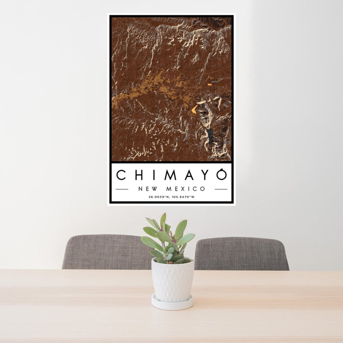 24x36 Chimayó New Mexico Map Print Portrait Orientation in Ember Style Behind 2 Chairs Table and Potted Plant
