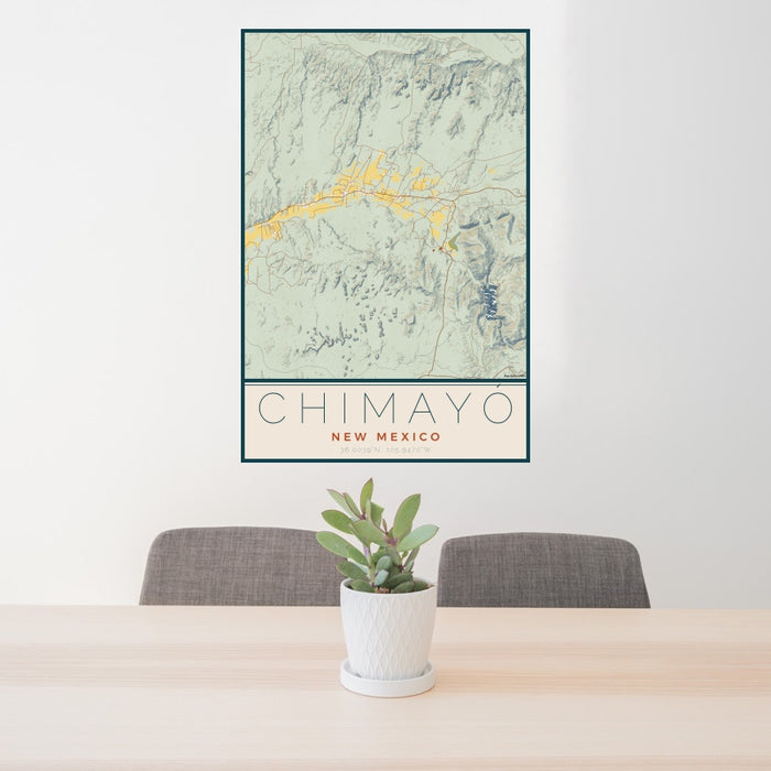 24x36 Chimayó New Mexico Map Print Portrait Orientation in Woodblock Style Behind 2 Chairs Table and Potted Plant