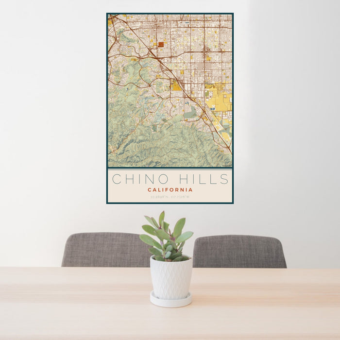 24x36 Chino Hills California Map Print Portrait Orientation in Woodblock Style Behind 2 Chairs Table and Potted Plant