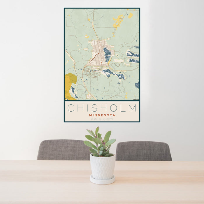 24x36 Chisholm Minnesota Map Print Portrait Orientation in Woodblock Style Behind 2 Chairs Table and Potted Plant