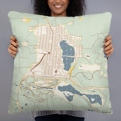 Person holding 22x22 Custom Chisholm Minnesota Map Throw Pillow in Woodblock