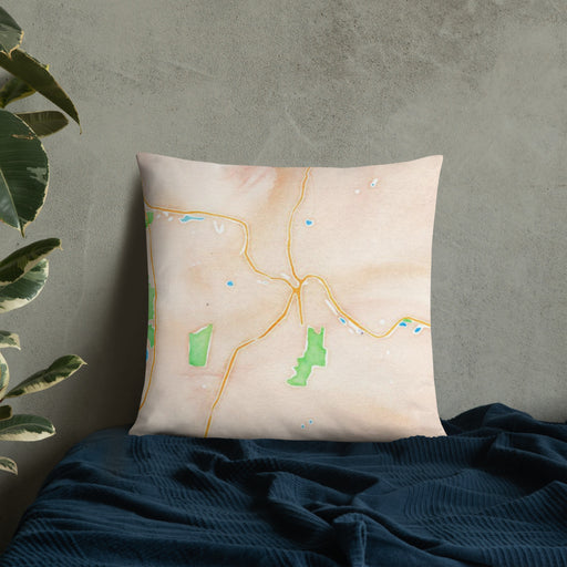 Custom Claremont New Hampshire Map Throw Pillow in Watercolor on Bedding Against Wall