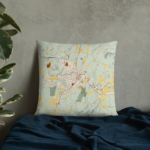 Custom Claremont New Hampshire Map Throw Pillow in Woodblock on Bedding Against Wall