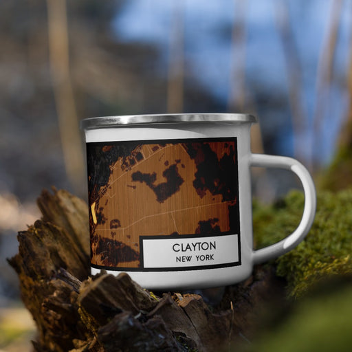 Right View Custom Clayton New York Map Enamel Mug in Ember on Grass With Trees in Background