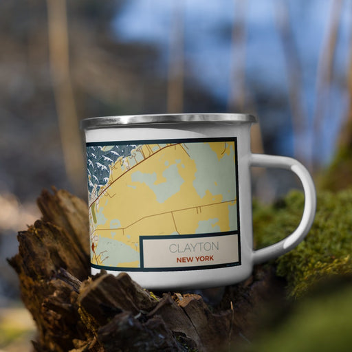 Right View Custom Clayton New York Map Enamel Mug in Woodblock on Grass With Trees in Background