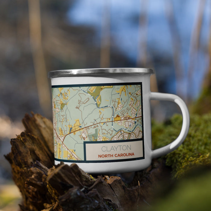 Right View Custom Clayton North Carolina Map Enamel Mug in Woodblock on Grass With Trees in Background