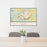 24x36 Cody Wyoming Map Print Lanscape Orientation in Woodblock Style Behind 2 Chairs Table and Potted Plant