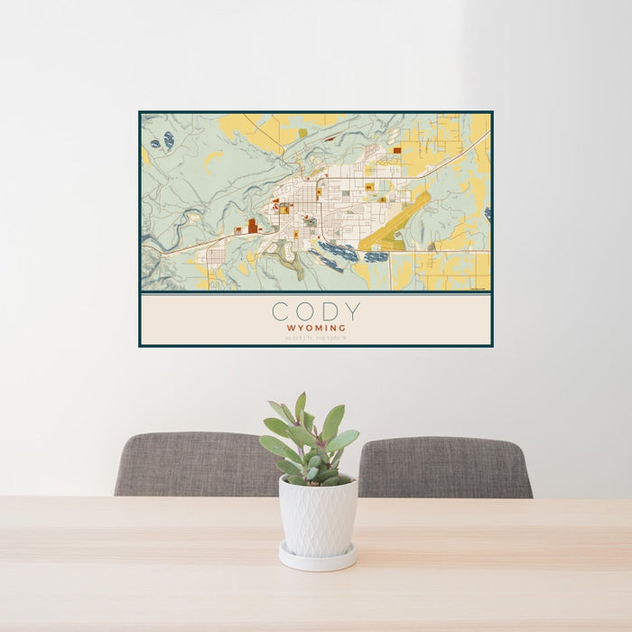 24x36 Cody Wyoming Map Print Lanscape Orientation in Woodblock Style Behind 2 Chairs Table and Potted Plant