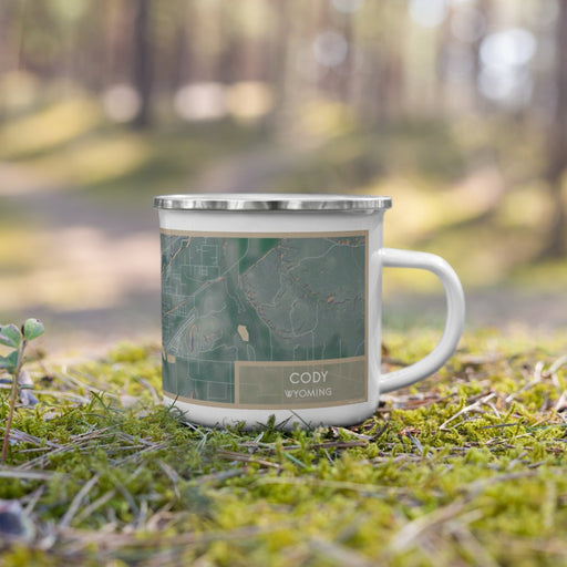 Right View Custom Cody Wyoming Map Enamel Mug in Afternoon on Grass With Trees in Background