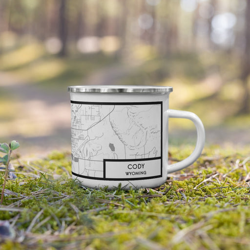 Right View Custom Cody Wyoming Map Enamel Mug in Classic on Grass With Trees in Background