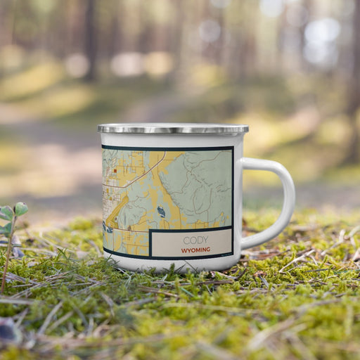 Right View Custom Cody Wyoming Map Enamel Mug in Woodblock on Grass With Trees in Background