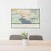 24x36 Coeur d'Alene Idaho Map Print Lanscape Orientation in Woodblock Style Behind 2 Chairs Table and Potted Plant