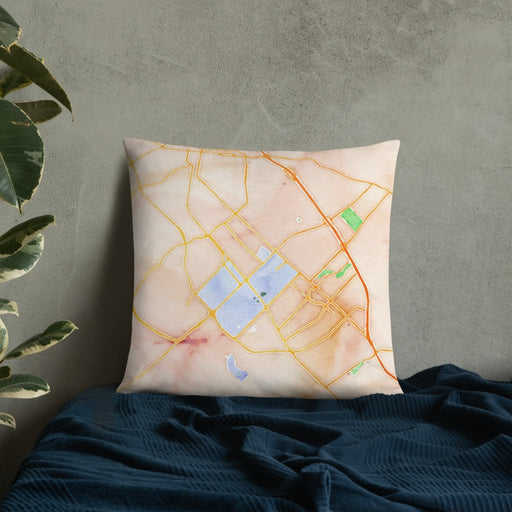Custom College Station Texas Map Throw Pillow in Watercolor on Bedding Against Wall