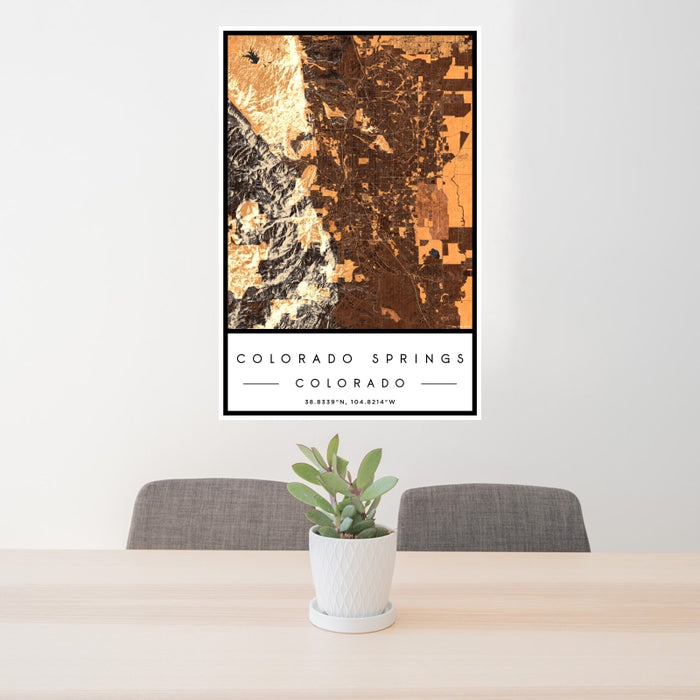 24x36 Colorado Springs Colorado Map Print Portrait Orientation in Ember Style Behind 2 Chairs Table and Potted Plant