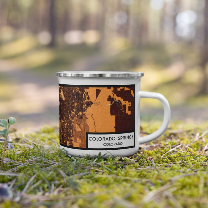 Right View Custom Colorado Springs Colorado Map Enamel Mug in Ember on Grass With Trees in Background