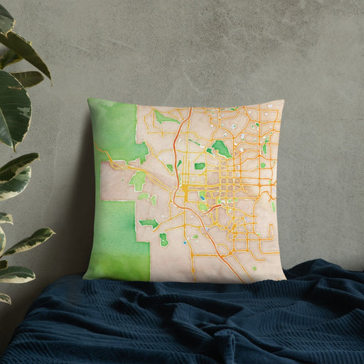 Custom Colorado Springs Colorado Map Throw Pillow in Watercolor on Bedding Against Wall
