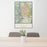 24x36 Colorado Springs Colorado Map Print Portrait Orientation in Woodblock Style Behind 2 Chairs Table and Potted Plant