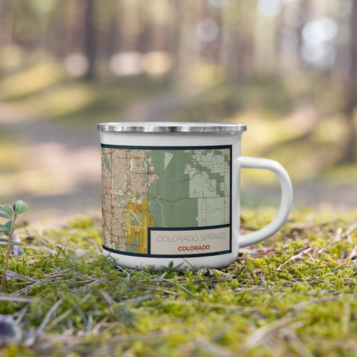 Right View Custom Colorado Springs Colorado Map Enamel Mug in Woodblock on Grass With Trees in Background