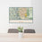 24x36 Colorado Springs Colorado Map Print Landscape Orientation in Woodblock Style Behind 2 Chairs Table and Potted Plant