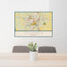 24x36 Columbia Missouri Map Print Landscape Orientation in Woodblock Style Behind 2 Chairs Table and Potted Plant