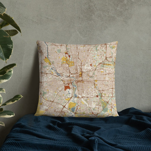 Custom Columbus Ohio Map Throw Pillow in Woodblock on Bedding Against Wall