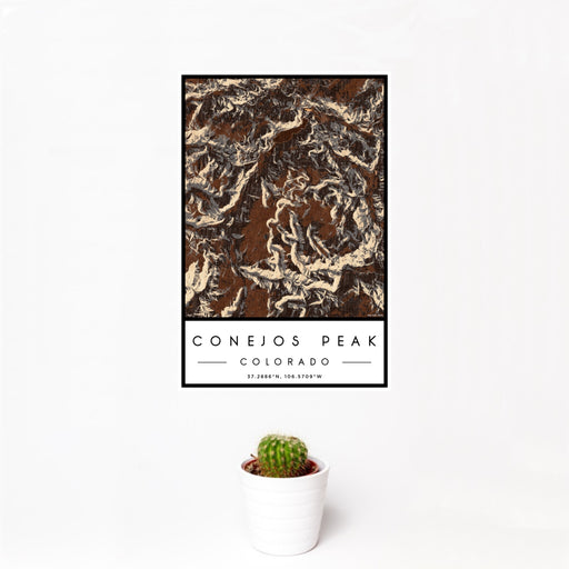 12x18 Conejos Peak Colorado Map Print Portrait Orientation in Ember Style With Small Cactus Plant in White Planter