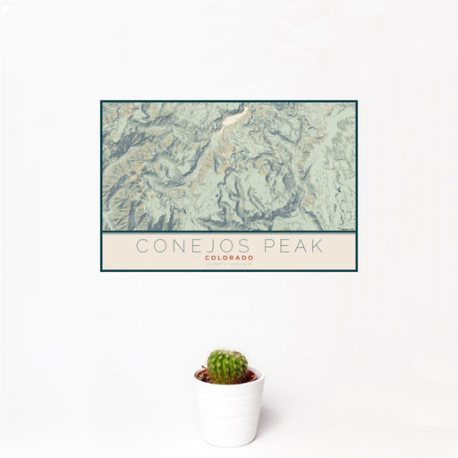 12x18 Conejos Peak Colorado Map Print Landscape Orientation in Woodblock Style With Small Cactus Plant in White Planter