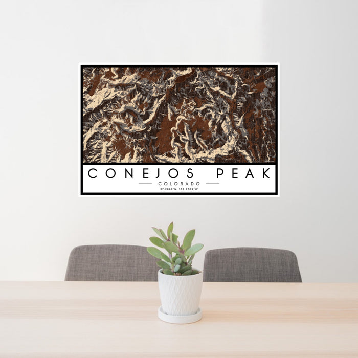 24x36 Conejos Peak Colorado Map Print Lanscape Orientation in Ember Style Behind 2 Chairs Table and Potted Plant
