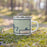 Right View Custom Cormorant Lake Manitoba Map Enamel Mug in Woodblock on Grass With Trees in Background