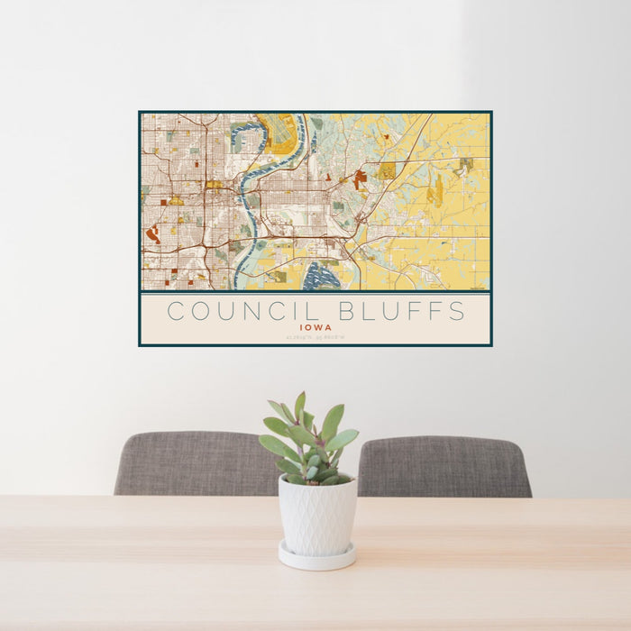 24x36 Council Bluffs Iowa Map Print Landscape Orientation in Woodblock Style Behind 2 Chairs Table and Potted Plant