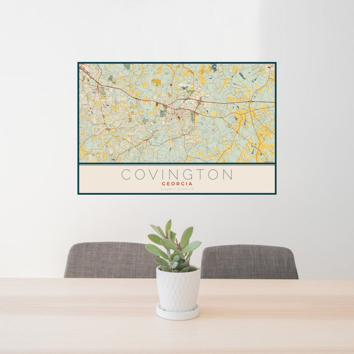 24x36 Covington Georgia Map Print Landscape Orientation in Woodblock Style Behind 2 Chairs Table and Potted Plant