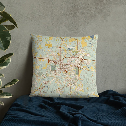 Custom Covington Georgia Map Throw Pillow in Woodblock on Bedding Against Wall