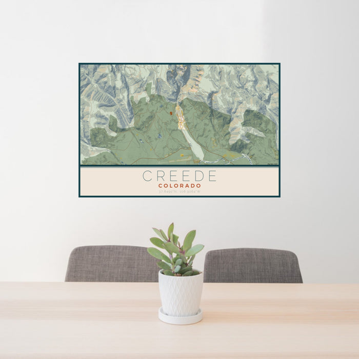 24x36 Creede Colorado Map Print Lanscape Orientation in Woodblock Style Behind 2 Chairs Table and Potted Plant