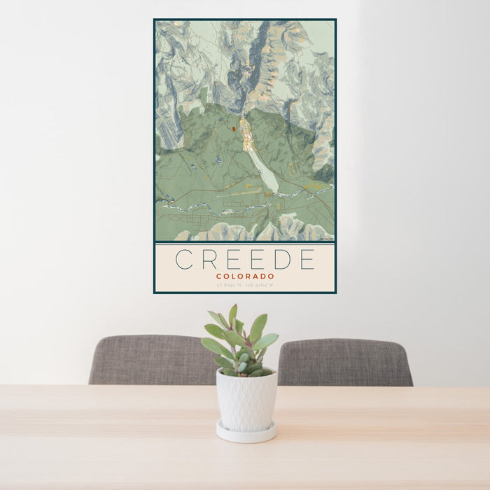 24x36 Creede Colorado Map Print Portrait Orientation in Woodblock Style Behind 2 Chairs Table and Potted Plant